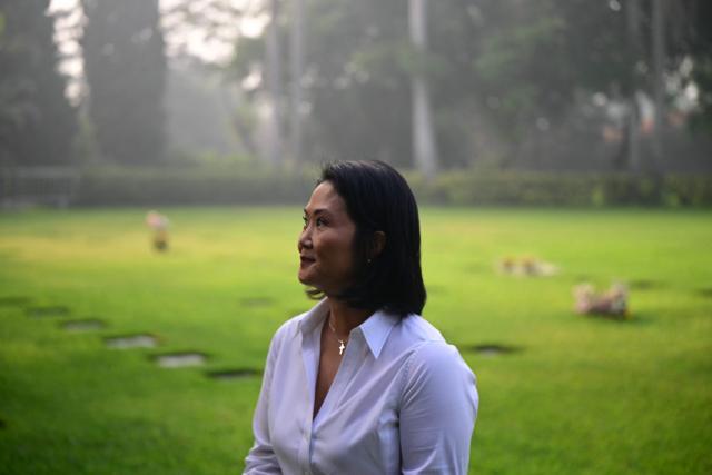 Peru's presidential candidate for the Fuerza Popular party, Keiko Fujimori visits the Campo Fe de Huachipa cemetery, where her father, Peru's former President (1990-200) Alberto Fujimori's remains are buried, in the east of Lima on April 12, 2026, during the presidential election. Peruvians will elect a new president from a record field of 35 candidates to lead a country plagued by organized crime and chronic political instability. (Photo by ERNESTO BENAVIDES / AFP)