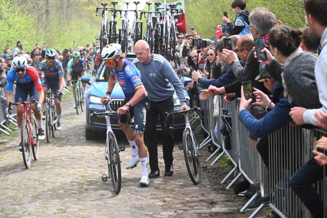 Alpecin-Premier Tech's Dutch rider Mathieu van der Poel changes his bike after a flat tire as he rides on the 'Trouйe d’Arenberg' cobblestone sector (Arenberg trench) during the 123rd edition of the Paris-Roubaix one-day classic cycling race, 258.3 km between Compiиgne and Roubaix, northern France, on April 12, 2026. (Photo by Etienne GARNIER / POOL / AFP)