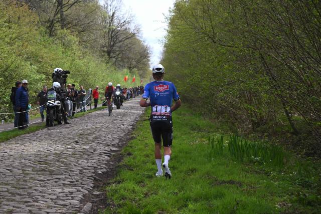 Alpecin-Premier Tech's Dutch rider Mathieu van der Poel waits to change his bike after a flat tire at the 'Trouйe d’Arenberg' cobblestone sector (Arenberg trench) during the 123rd edition of the Paris-Roubaix one-day classic cycling race, 258.3 km between Compiиgne and Roubaix, northern France, on April 12, 2026. (Photo by Etienne GARNIER / POOL / AFP)