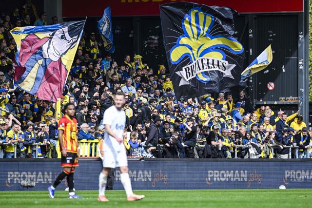 Union's supporters wave flags and cheer their team   during the Belgian Pro League play-off football match between KV Mechelen and Royale Union Saint-Gilloise at the Achter de Kazerne stadium in Mechelen on April 12, 2026. (Photo by Tom Goyvaerts / Belga / AFP) / Belgium OUT