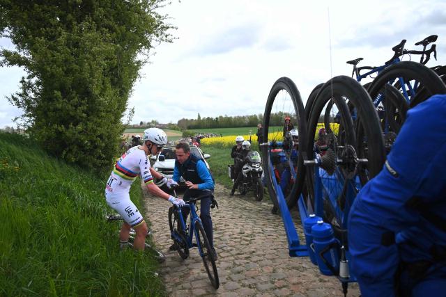 UAE Team Emirates XRG's Slovenian rider Tadej Pogacar changes his bike after a flat tire during the 123rd edition of the Paris-Roubaix one-day classic cycling race, 258.3 km between Compiègne and Roubaix, northern France, on April 12, 2026. (Photo by Etienne GARNIER / POOL / AFP)
