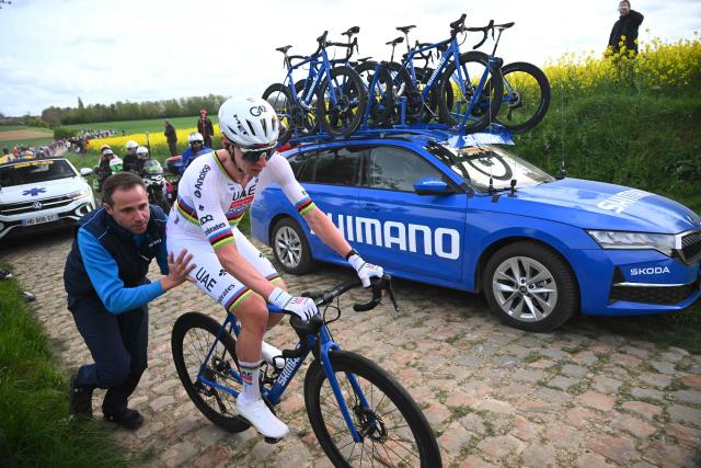 UAE Team Emirates XRG's Slovenian rider Tadej Pogacar changes his bike after a flat tire during the 123rd edition of the Paris-Roubaix one-day classic cycling race, 258.3 km between Compiègne and Roubaix, northern France, on April 12, 2026. (Photo by Etienne GARNIER / POOL / AFP)