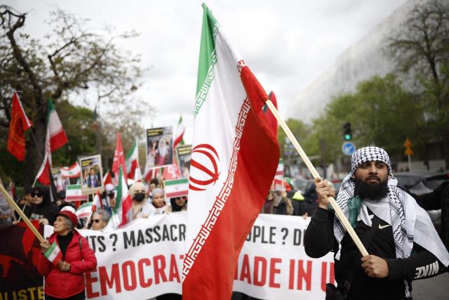 A protester holds an Iranian flag during a rally against the Yadan bill, which aims to combat new forms of anti-Semitism, in Paris on April 12, 2026. The proposed bill, named after French lawmaker from the presidential camp Caroline Yadan and will be debated next April 16 and 17, aims to combat "new forms" of anti-Semitism and has met with strong reservations. Its opponents, particularly on the left, argue that it would threaten freedom of expression and perpetuate a conflation of Jews and Israel. (Photo by Ian LANGSDON / AFP)
