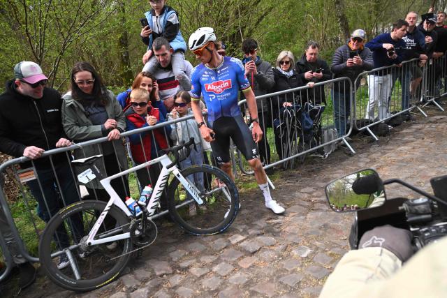Alpecin-Premier Tech's Dutch rider Mathieu van der Poel waits to change his bike after a flat tire at the 'Trouйe d’Arenberg' cobblestone sector (Arenberg trench) during the 123rd edition of the Paris-Roubaix one-day classic cycling race, 258.3 km between Compiиgne and Roubaix, northern France, on April 12, 2026. (Photo by Etienne GARNIER / POOL / AFP)