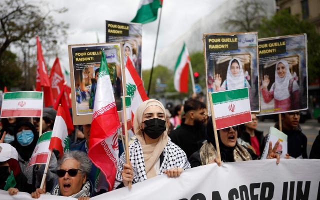 Protesters hold Iranian flags during a rally against the Yadan bill, which aims to combat new forms of anti-Semitism, in Paris on April 12, 2026. The proposed bill, named after French lawmaker from the presidential camp Caroline Yadan and will be debated next April 16 and 17, aims to combat "new forms" of anti-Semitism and has met with strong reservations. Its opponents, particularly on the left, argue that it would threaten freedom of expression and perpetuate a conflation of Jews and Israel. (Photo by Ian LANGSDON / AFP)