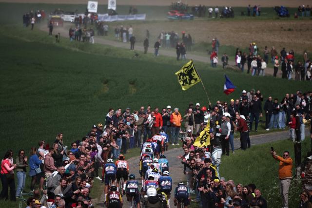 The pack rides during the 123rd edition of the Paris-Roubaix one-day classic cycling race, 258.3 km between Compiègne and Roubaix, northern France, on April 12, 2026. (Photo by Anne-Christine POUJOULAT / AFP)