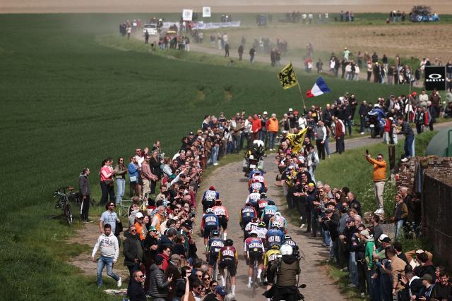 The pack rides during the 123rd edition of the Paris-Roubaix one-day classic cycling race, 258.3 km between Compiègne and Roubaix, northern France, on April 12, 2026. (Photo by Anne-Christine POUJOULAT / AFP)