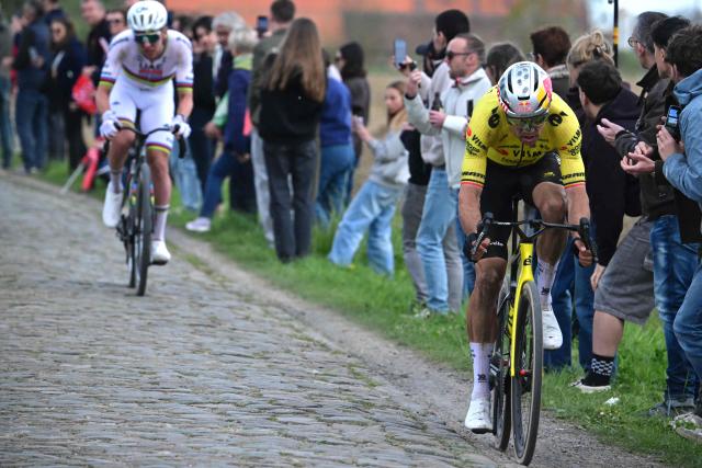 Team Visma - Lease a Bike's Belgian rider Wout van Aert cycles ahead of UAE Team Emirates XRG's Slovenian rider Tadej Pogacar during the 123rd edition of the Paris-Roubaix one-day classic cycling race, 258.3 km between Compiègne and Roubaix, northern France, on April 12, 2026. (Photo by Bernard PAPON / POOL / AFP)