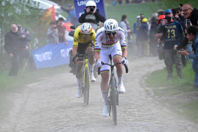 UAE Team Emirates XRG's Slovenian rider Tadej Pogacar cycles ahead of Team Visma - Lease a Bike's Belgian rider Wout van Aert during the 123rd edition of the Paris-Roubaix one-day classic cycling race, 258.3 km between Compiègne and Roubaix, northern France, on April 12, 2026. (Photo by Bernard PAPON / POOL / AFP)