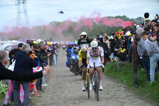 UAE Team Emirates XRG's Slovenian rider Tadej Pogacar cycles ahead of Team Visma - Lease a Bike's Belgian rider Wout van Aert during the 123rd edition of the Paris-Roubaix one-day classic cycling race, 258.3 km between Compiègne and Roubaix, northern France, on April 12, 2026. (Photo by Bernard PAPON / POOL / AFP)