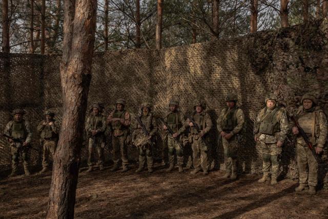 Ukrainian military members of the 33rd separate mechanised brigade attend a prayer service to celebrate Orthodox Easter, in the Kharkiv region, on April 12, 2026, amid the Russian invasion of Ukraine. (Photo by Roman PILIPEY / AFP)
