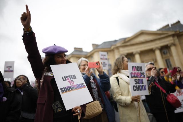 Protesters take part in a demonstration organised by the Collectif Abolition, a network of associations and activists aiming to end prostitution, on the occasion of the tenth anniversary of the prostitution law in France, in front of Pantheon in Paris on April 12, 2026. The 2016 French law made buying sex illegal, decriminalised sex workers, and created support programs to help them exit prostitution. (Photo by Ian LANGSDON / AFP)