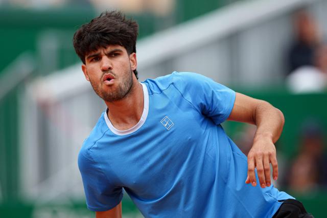 Spain's Carlos Alcaraz reacts after winning a game against Italy's Jannik Sinner during the Monte Carlo ATP Masters Series Tournament final tennis match on Court Rainier III at the Monte-Carlo Country Club in Roquebrune-Cap-Martin, south-eastern France on April 12, 2026. (Photo by Valery HACHE / AFP)
