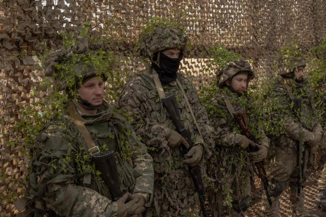 Ukrainian military members of the 33rd separate mechanised brigade attend a prayer service to celebrate Orthodox Easter, in the Kharkiv region, on April 12, 2026, amid the Russian invasion of Ukraine. (Photo by Roman PILIPEY / AFP)