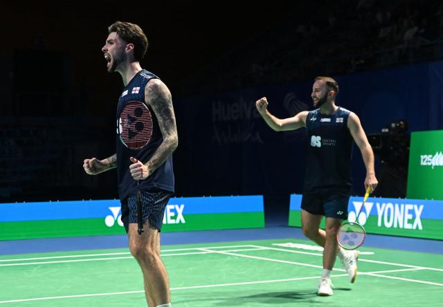 England's Ben Lane and Sean Vendy celebrate during their men’s doubles final match against France's Christo Popov and Toma Junior Popov of the Badminton European Championships' finale at the Carolina Marin Sports Palace in Huelva on April 12, 2026. (Photo by Cristina Quicler / AFP)