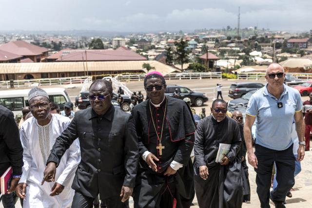 Bamenda Archbishop Andrew Nkea Fuanya (C) arrives with a delegation from the Vatican to Saint Joseph Metropolitan Cathedral ahead of Pope Leo XIV’s visit in Bamenda, on April 12, 2026. (Photo by PATRICK MEINHARDT / AFP)