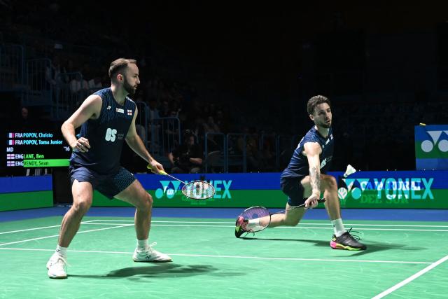 England's Ben Lane and Sean Vendy return to France's Christo Popov and Toma Junior Popov during their men’s doubles final match of the Badminton European Championships' finale at the Carolina Marin Sports Palace in Huelva on April 12, 2026. (Photo by Cristina Quicler / AFP)