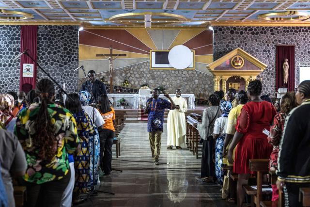 Members of a choir rehearse ahead of Pope Leo XIV’s visit at Saint Joseph Metropolitan Cathedral in Bamenda, on April 12, 2026. (Photo by PATRICK MEINHARDT / AFP)