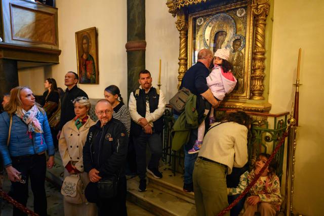 An Orthodox devotee kisses an icon as worshippers attend the Easter service at the Patriarchal Church of St. George, in Istanbul on April 12, 2026. (Photo by Yasin AKGUL / AFP)