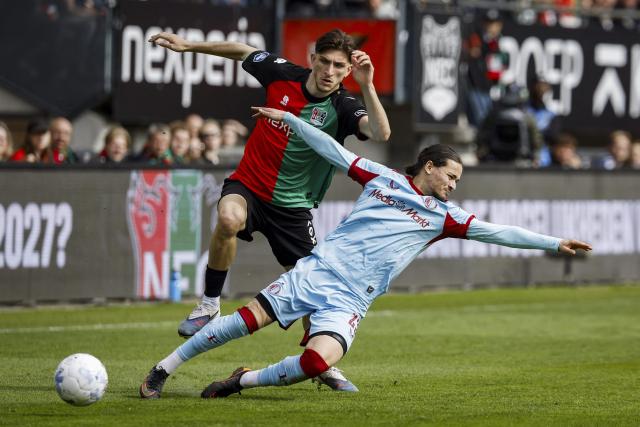 NEC Nijmegen's Turkish defender Ahmetcan Kaplan (L) fights for the ball with Feyenoord's French forward #23 Anis Hadj Moussa during the Dutch Eredivisie football match between NEC Nijmegen and Feyenoord at De Goffert stadium  in Nijmegen on April 12, 2026. (Photo by Bas Czerwinski / ANP / AFP) / Netherlands OUT
