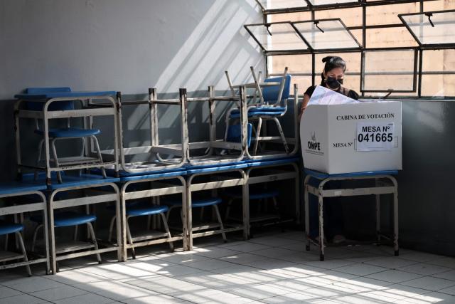 A woman votes in Lima on April 12, 2026, during general elections. Peruvians will elect a new president from a record field of 35 candidates to lead a country plagued by organized crime and chronic political instability. (Photo by Connie FRANCE / AFP)