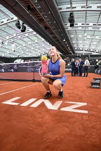 Russia's Mirra Andreeva poses with her golden trophy after winning the women's single final match of the WTA Upper Austria Women's Linz tennis tournament in Linz, Austria on April 12, 2026. (Photo by BARBARA GINDL / APA / AFP) / Austria OUT