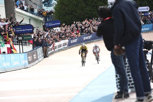 Team Visma - Lease a Bike's Belgian rider Wout van Aert sprints to win ahead of UAE Team Emirates XRG's Slovenian rider Tadej Pogacar to win the 123rd edition of the Paris-Roubaix one-day classic cycling race, 258.3 km between Compiègne and Roubaix, at the Vélodrome André-Pétrieux in Roubaix, northern France, on April 12, 2026. (Photo by Anne-Christine POUJOULAT / AFP)