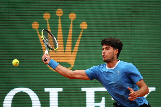 Spain's Carlos Alcaraz eyes the ball as he hits a return to Italy's Jannik Sinnerduring the Monte Carlo ATP Masters Series Tournament final tennis match on Court Rainier III at the Monte-Carlo Country Club in Roquebrune-Cap-Martin, south-eastern France on April 12, 2026. (Photo by Valery HACHE / AFP)