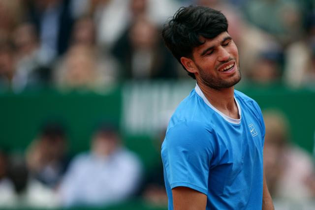 Spain's Carlos Alcaraz reacts after Italy's Jannik Sinner won a game during the Monte Carlo ATP Masters Series Tournament final tennis match on Court Rainier III at the Monte-Carlo Country Club in Roquebrune-Cap-Martin, south-eastern France on April 12, 2026. (Photo by Valery HACHE / AFP)