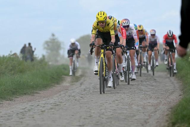 The pack rides on a cobblestone sector during the 6th edition of the Women Paris-Roubaix one-day classic cycling race, 143.1 km between Denain and Roubaix, northern France, on April 12, 2026. (Photo by NICOLAS TUCAT / AFP)