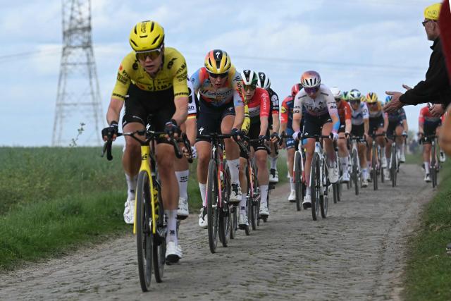 The pack rides on a cobblestone sector during the 6th edition of the Women Paris-Roubaix one-day classic cycling race, 143.1 km between Denain and Roubaix, northern France, on April 12, 2026. (Photo by NICOLAS TUCAT / AFP)