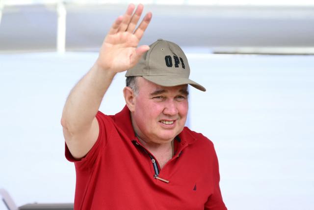 Peru's presidential candidate Rafael Lopez Aliaga, for the Renovacion Popular party, waves as he votes during the presidential election in Lima on April 12, 2026. Peruvians elect a new president from a record field of 35 candidates to lead a country plagued by organized crime and chronic political instability. (Photo by Luis ROBAYO / AFP)