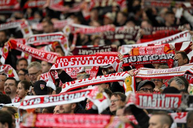 Stuttgart fans display their scarves prior to the German first division Bundesliga football match between VfB Stuttgart and Hamburger SV in Stuttgart, southwestern Germany on April 12, 2026. (Photo by THOMAS KIENZLE / AFP) / DFL REGULATIONS PROHIBIT ANY USE OF PHOTOGRAPHS AS IMAGE SEQUENCES AND/OR QUASI-VIDEO