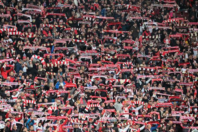 Stuttgart fans display their scarves prior to the German first division Bundesliga football match between VfB Stuttgart and Hamburger SV in Stuttgart, southwestern Germany on April 12, 2026. (Photo by THOMAS KIENZLE / AFP) / DFL REGULATIONS PROHIBIT ANY USE OF PHOTOGRAPHS AS IMAGE SEQUENCES AND/OR QUASI-VIDEO