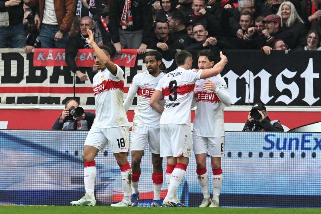 Stuttgart's German midfielder #06 Angelo Stiller (R) celebrates scoring the opening goal with his teammates during the German first division Bundesliga football match between VfB Stuttgart and Hamburger SV in Stuttgart, southwestern Germany on April 12, 2026. (Photo by THOMAS KIENZLE / AFP) / DFL REGULATIONS PROHIBIT ANY USE OF PHOTOGRAPHS AS IMAGE SEQUENCES AND/OR QUASI-VIDEO