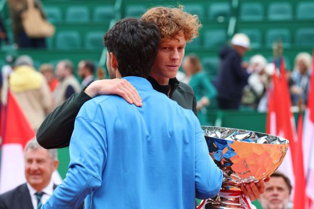 Italy's Jannik Sinner (R) embraces with Spain's Carlos Alcaraz after winning the Monte Carlo ATP Masters Series Tournament final tennis match on Court Rainier III at the Monte-Carlo Country Club in Roquebrune-Cap-Martin, south-eastern France on April 12, 2026. (Photo by Valery HACHE / AFP)