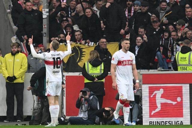 Stuttgart's German midfielder #10 Chris Fuehrich (L) celebrates scoring the 2-0 goal  during the German first division Bundesliga football match between VfB Stuttgart and Hamburger SV in Stuttgart, southwestern Germany on April 12, 2026. (Photo by THOMAS KIENZLE / AFP) / DFL REGULATIONS PROHIBIT ANY USE OF PHOTOGRAPHS AS IMAGE SEQUENCES AND/OR QUASI-VIDEO