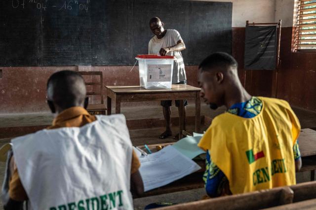 TOPSHOT - A voter casts his ballot at a polling station set up in a primary school in Lokossa on April 12, 2026 during Benin's presidential elections. (Photo by Yanick Folly / AFP)