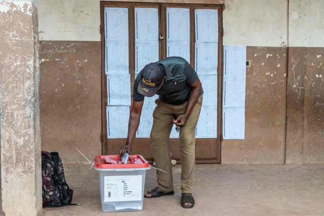 A voter casts his ballot at a polling station set up in a primary school in Lokossa on April 12, 2026 during Benin's presidential elections. (Photo by Yanick Folly / AFP)