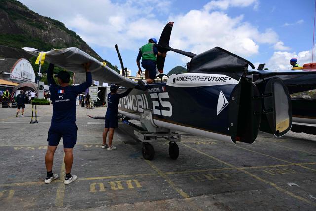 Crew members prepare the France SailGP Team vessel ahead of SailGP Rio race day 2 at the Rio de Janeiro Yacht Club in Guanabara Bay, Rio de Janeiro, Brazil, on April 12, 2026. (Photo by Pablo PORCIUNCULA / AFP)