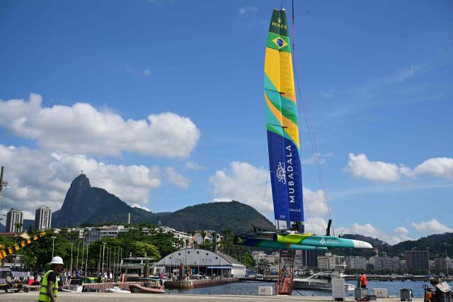Crew members prepare the Mubadala Brazil SailGP Team vessel ahead of SailGP Rio race day 2 at the Rio de Janeiro Yacht Club in Guanabara Bay, Rio de Janeiro, Brazil, on April 12, 2026. (Photo by Pablo PORCIUNCULA / AFP)