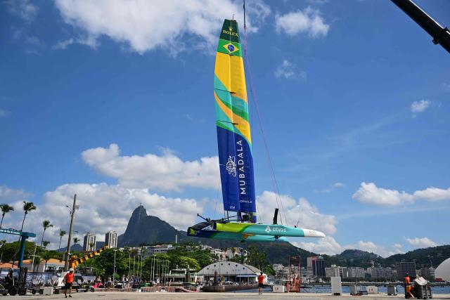 Crew members prepare the Mubadala Brazil SailGP Team vessel ahead of SailGP Rio race day 2 at the Rio de Janeiro Yacht Club in Guanabara Bay, Rio de Janeiro, Brazil, on April 12, 2026. (Photo by Pablo PORCIUNCULA / AFP)