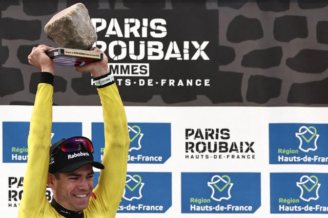 Winner Team Visma - Lease a Bike's Belgian rider Wout van Aert celebrates on the podium of the 123rd edition of the Paris-Roubaix one-day classic cycling race, 258.3 km between Compiègne and Roubaix, at the Vélodrome André-Pétrieux in Roubaix, northern France, on April 12, 2026. (Photo by Anne-Christine POUJOULAT / AFP)