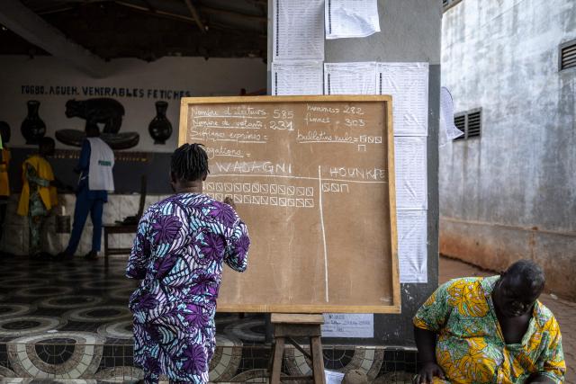 TOPSHOT - An electoral official writes the results on a board during vote counting at a polling station in Porto-Novo, on April 12, 2026 during Benin's presidential elections. (Photo by OLYMPIA DE MAISMONT / AFP)