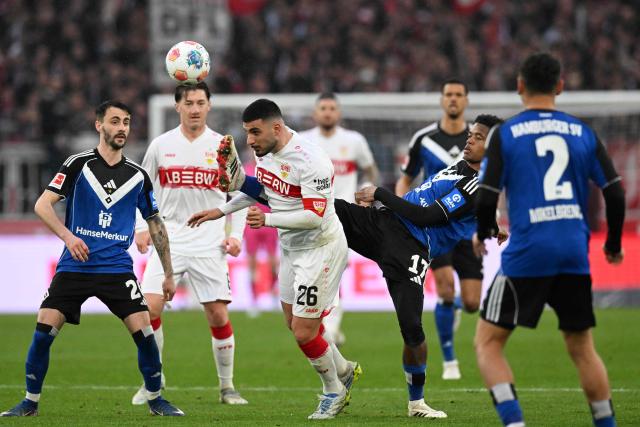 Stuttgart's German forward #26 Deniz Undav (3L) and Hamburg's Comorian defender #17 Warmed Omari (2R) vie for the ball during the German first division Bundesliga football match between VfB Stuttgart and Hamburger SV in Stuttgart, southwestern Germany on April 12, 2026. (Photo by THOMAS KIENZLE / AFP) / DFL REGULATIONS PROHIBIT ANY USE OF PHOTOGRAPHS AS IMAGE SEQUENCES AND/OR QUASI-VIDEO