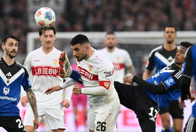 Stuttgart's German forward #26 Deniz Undav (C) and Hamburg's Comorian defender #17 Warmed Omari (R) vie for the ball during the German first division Bundesliga football match between VfB Stuttgart and Hamburger SV in Stuttgart, southwestern Germany on April 12, 2026. (Photo by THOMAS KIENZLE / AFP) / DFL REGULATIONS PROHIBIT ANY USE OF PHOTOGRAPHS AS IMAGE SEQUENCES AND/OR QUASI-VIDEO