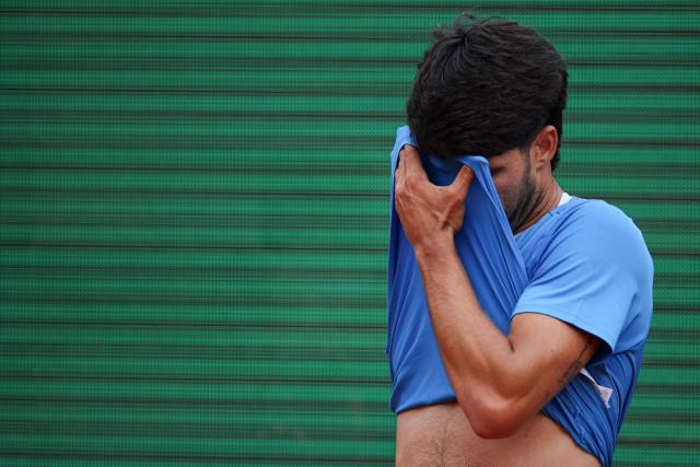 Spain's Carlos Alcaraz reacts as he plays against Italy's Jannik Sinner during the Monte Carlo ATP Masters Series Tournament final tennis match on Court Rainier III at the Monte-Carlo Country Club in Roquebrune-Cap-Martin, south-eastern France on April 12, 2026. (Photo by Valery HACHE / AFP)