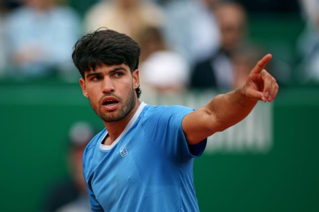Spain's Carlos Alcaraz gestures as he plays against Italy's Jannik Sinner during the Monte Carlo ATP Masters Series Tournament final tennis match on Court Rainier III at the Monte-Carlo Country Club in Roquebrune-Cap-Martin, south-eastern France on April 12, 2026. (Photo by Valery HACHE / AFP)