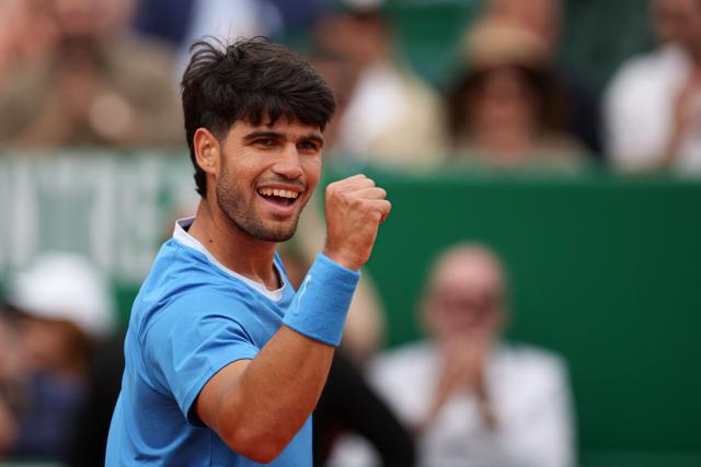 Spain's Carlos Alcaraz reacts after winning a game against Italy's Jannik Sinner during the Monte Carlo ATP Masters Series Tournament final tennis match on Court Rainier III at the Monte-Carlo Country Club in Roquebrune-Cap-Martin, south-eastern France on April 12, 2026. (Photo by Valery HACHE / AFP)
