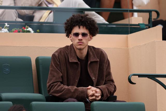 Monaco's French midfielder Maghnes Akliouche looks on as he attends the Monte Carlo ATP Masters Series Tournament final tennis match between Spain's Carlos Alcaraz and Italy's Jannik Sinner on Court Rainier III at the Monte-Carlo Country Club in Roquebrune-Cap-Martin, south-eastern France on April 12, 2026. (Photo by Valery HACHE / AFP)